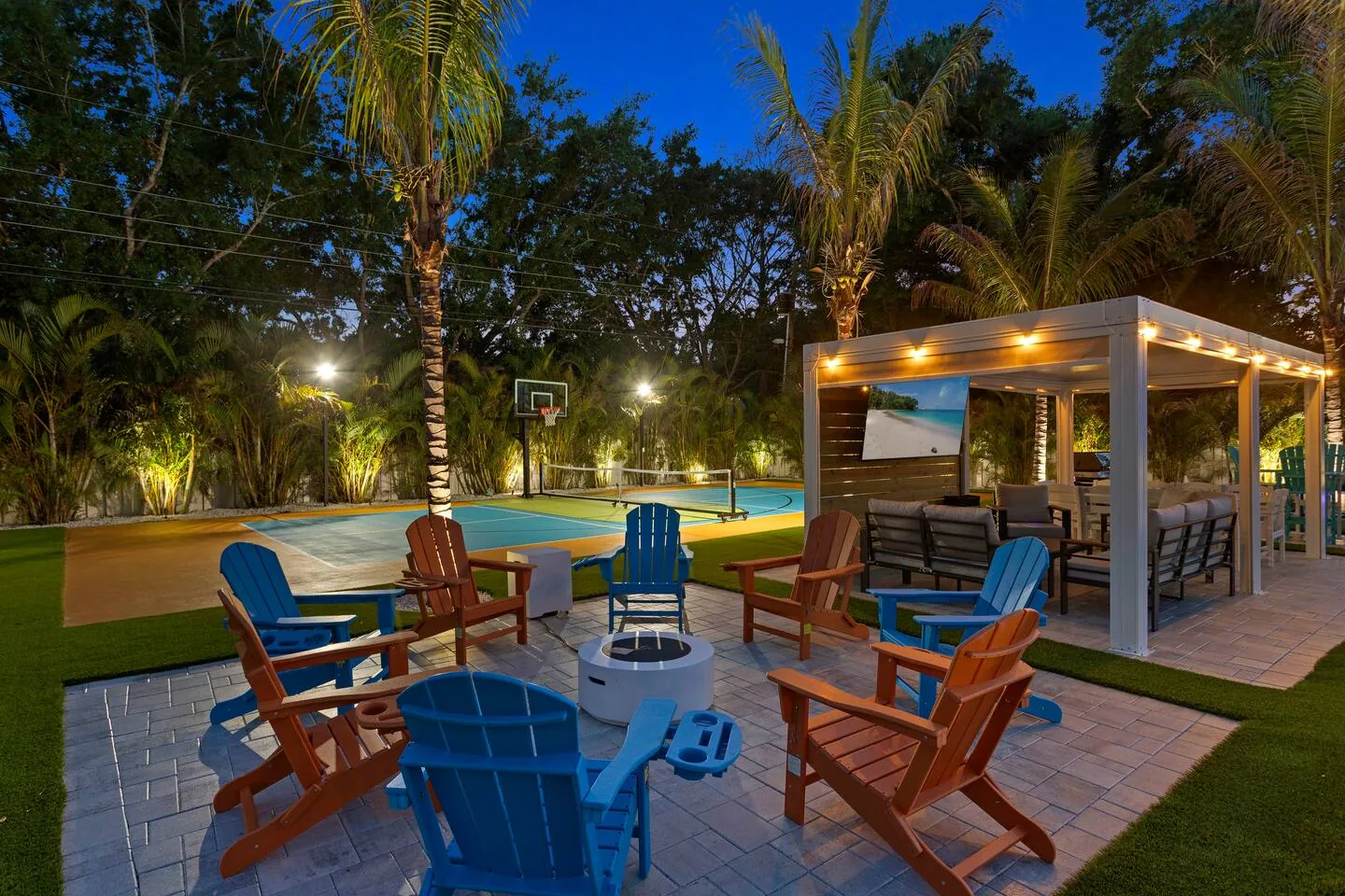 Fire pit and pergola at night at Private Backyard Resort, Bradenton, Florida