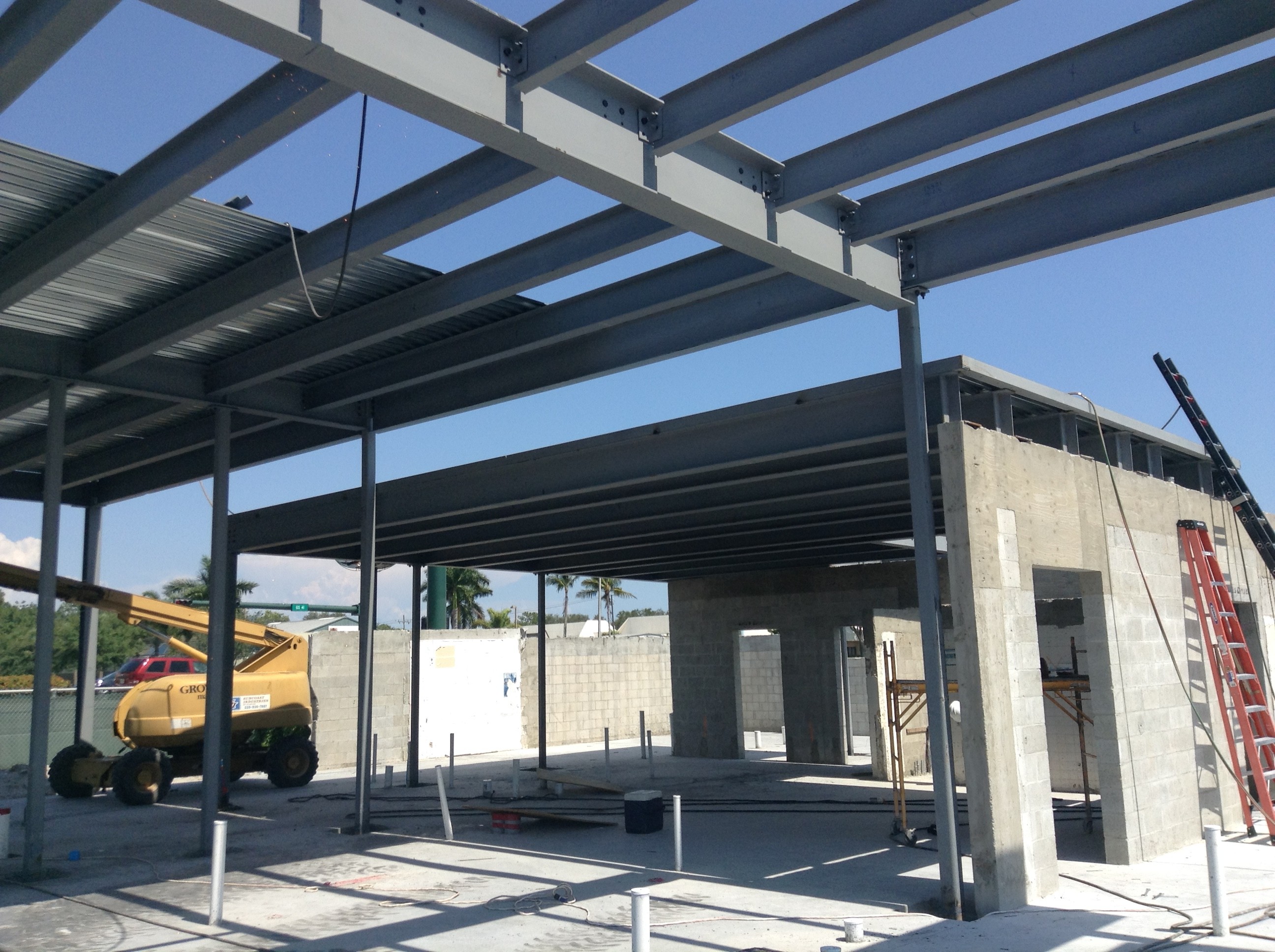 a medium-sized concrete building being built with a metal frame