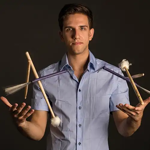Evan Sherman juggling drum sticks.