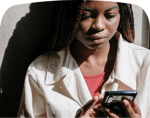 an image of a man of african descent holding their phone reading from it digital photo