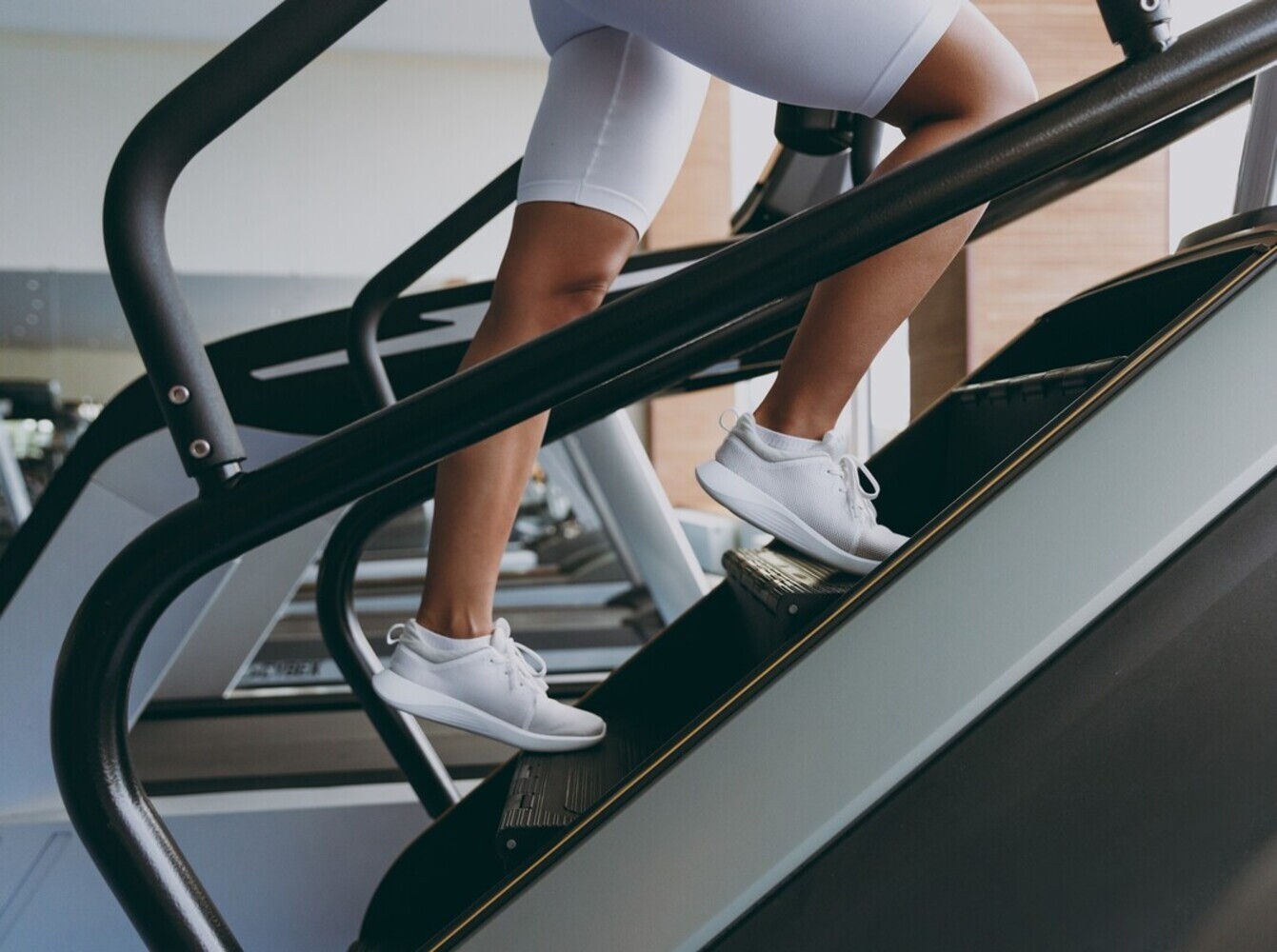 shot of a woman’s legs as she works out on a StairMaster to lose weight at the gym