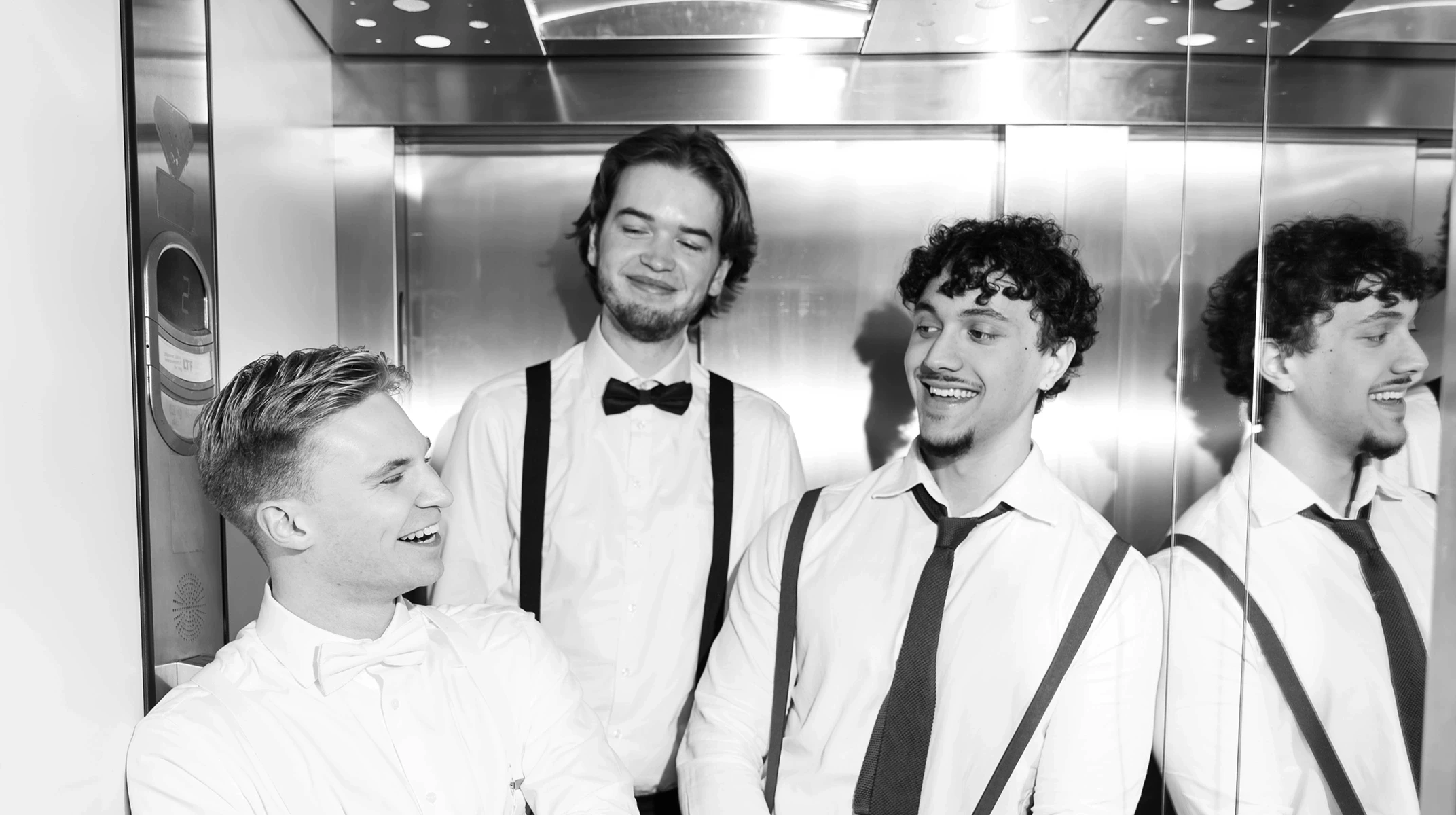 A red hot air balloon glows at sunset over mountains.