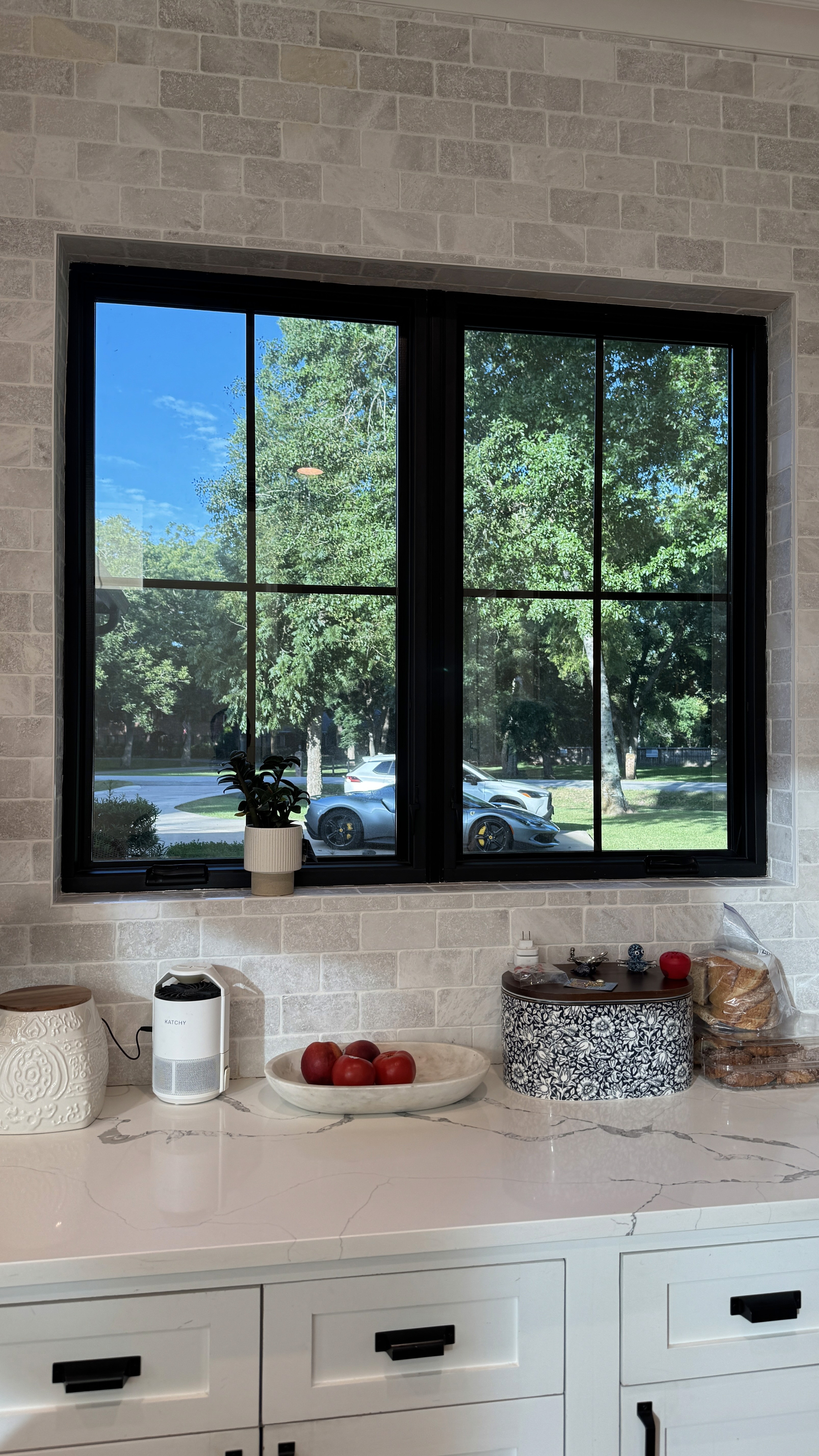 Residential window with tinted glass in a brick fireplace room