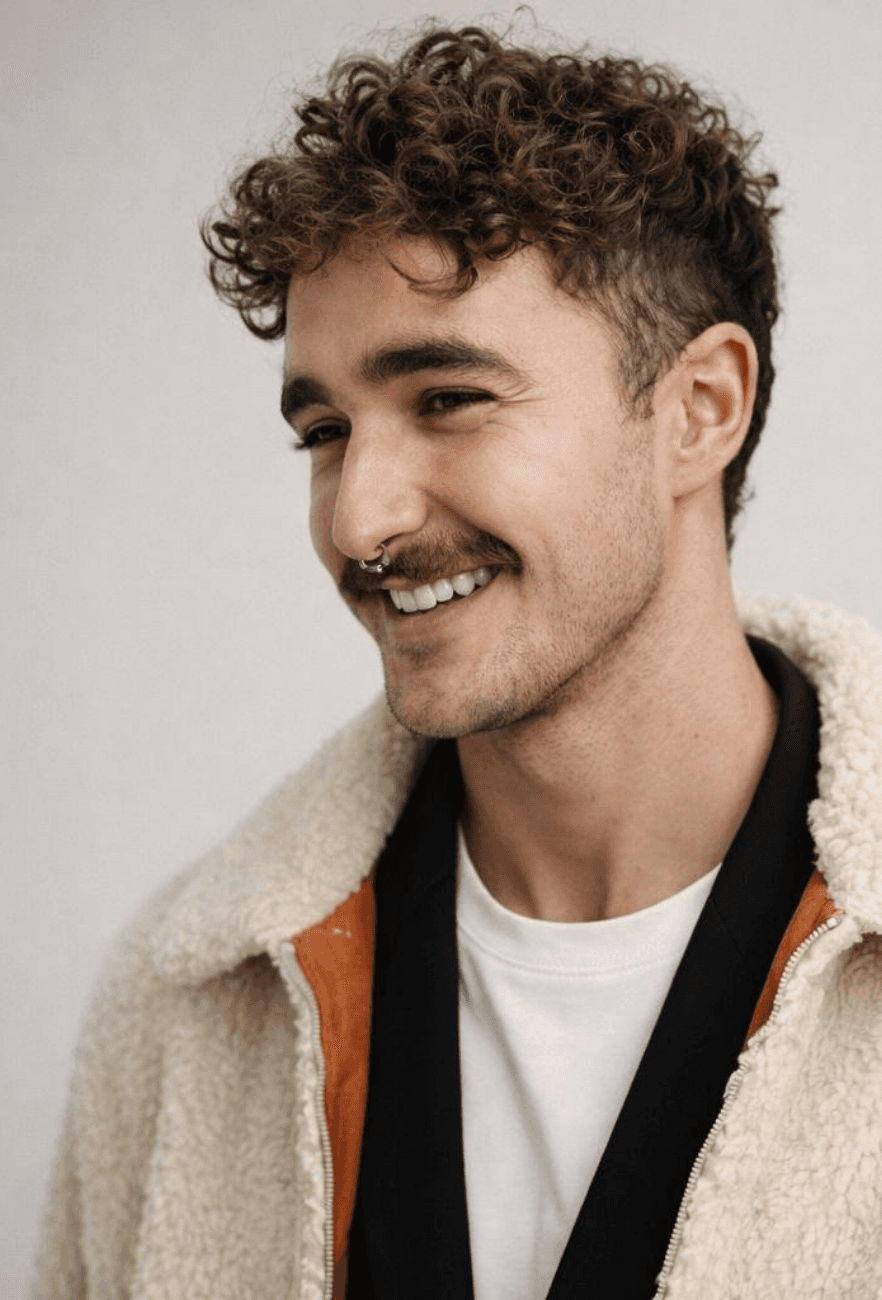 Portrait of a person in dark clothing speaking on a phone