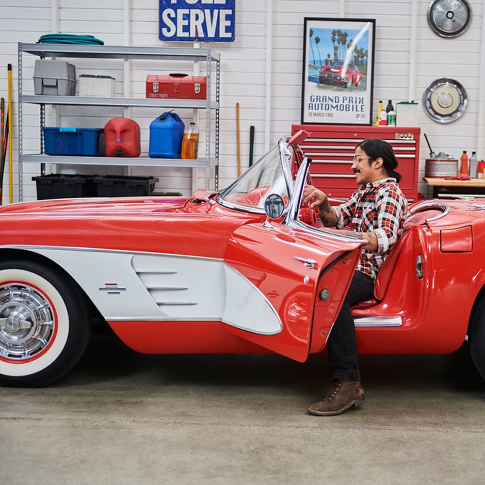 Man getting inside red car