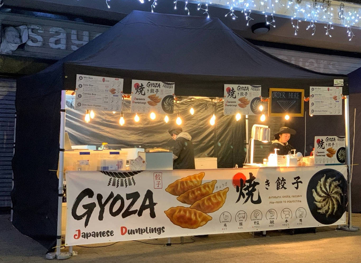 A thoughtful young person with dark hair gazes to the side, captured in soft black and white lighting.