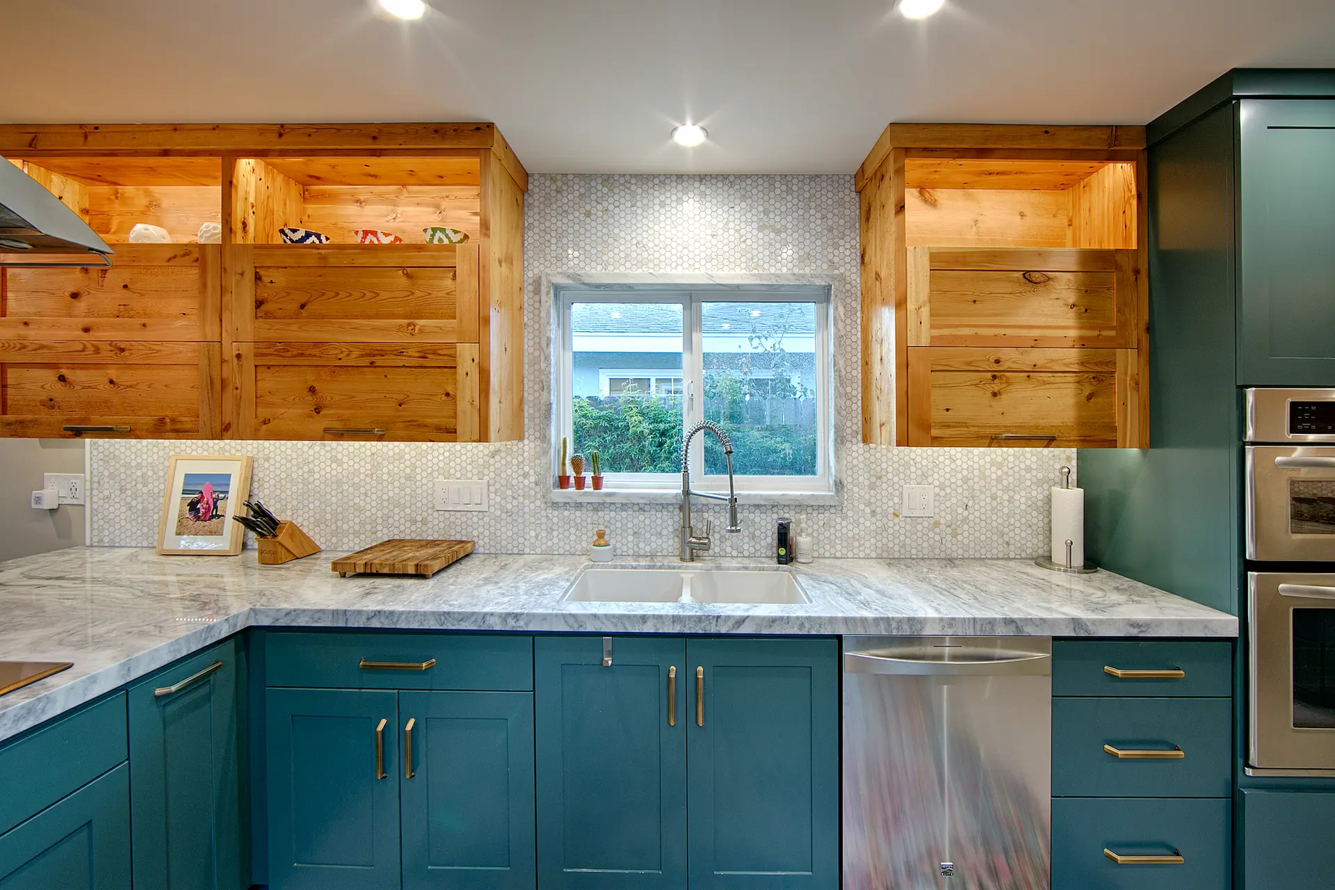 Teal cabinetry with wooden upper shelves and marble backsplash in Huntington Beach Kitchen & BathRemodel.