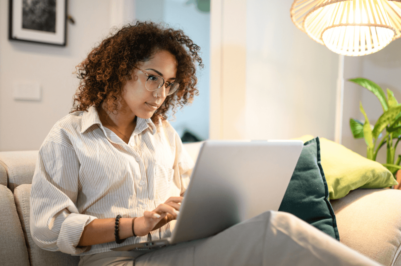 woman using laptop sitting on the sofa