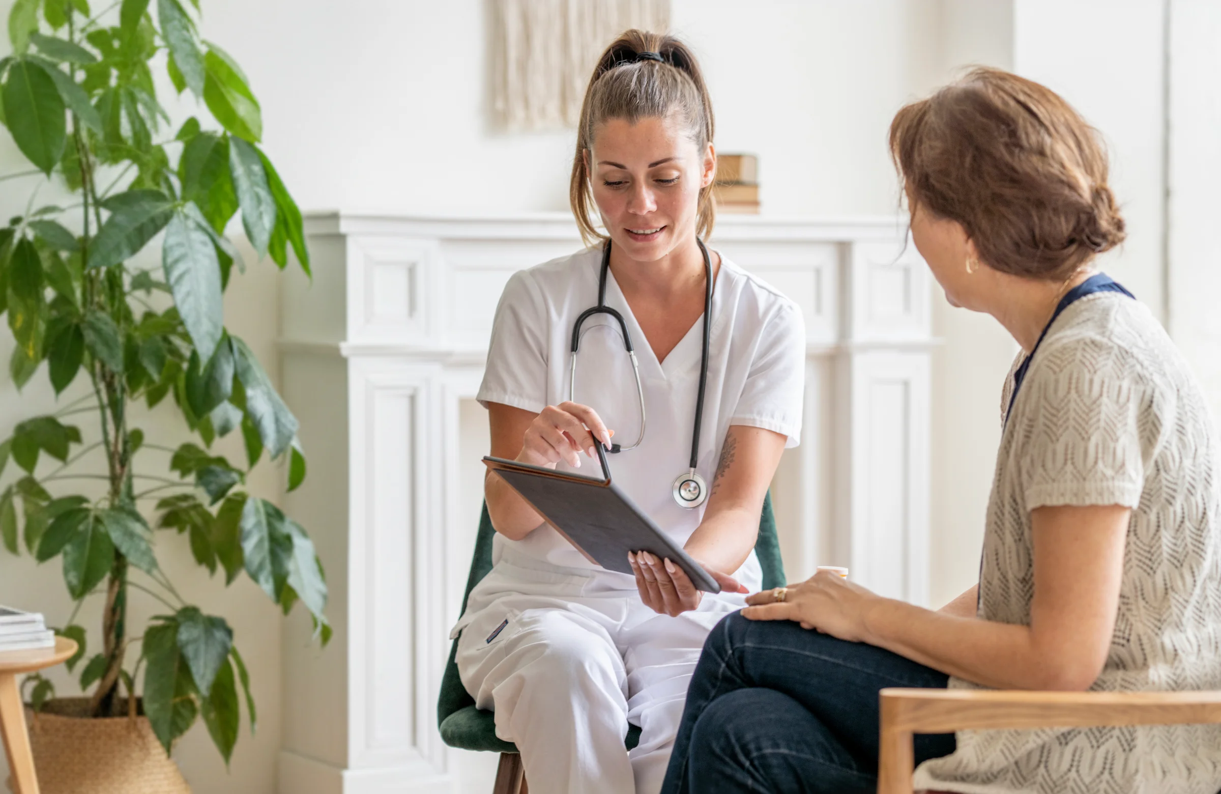 Community nurse discussing bladder health with client at home in Brisbane