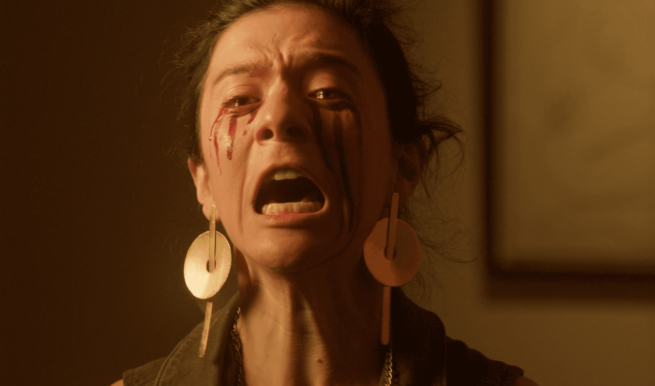 Two people clinking cocktail glasses over appetizers