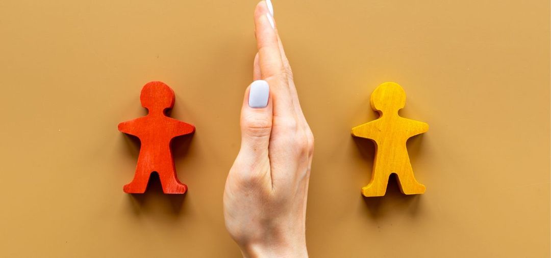 two people blocks with hand between them