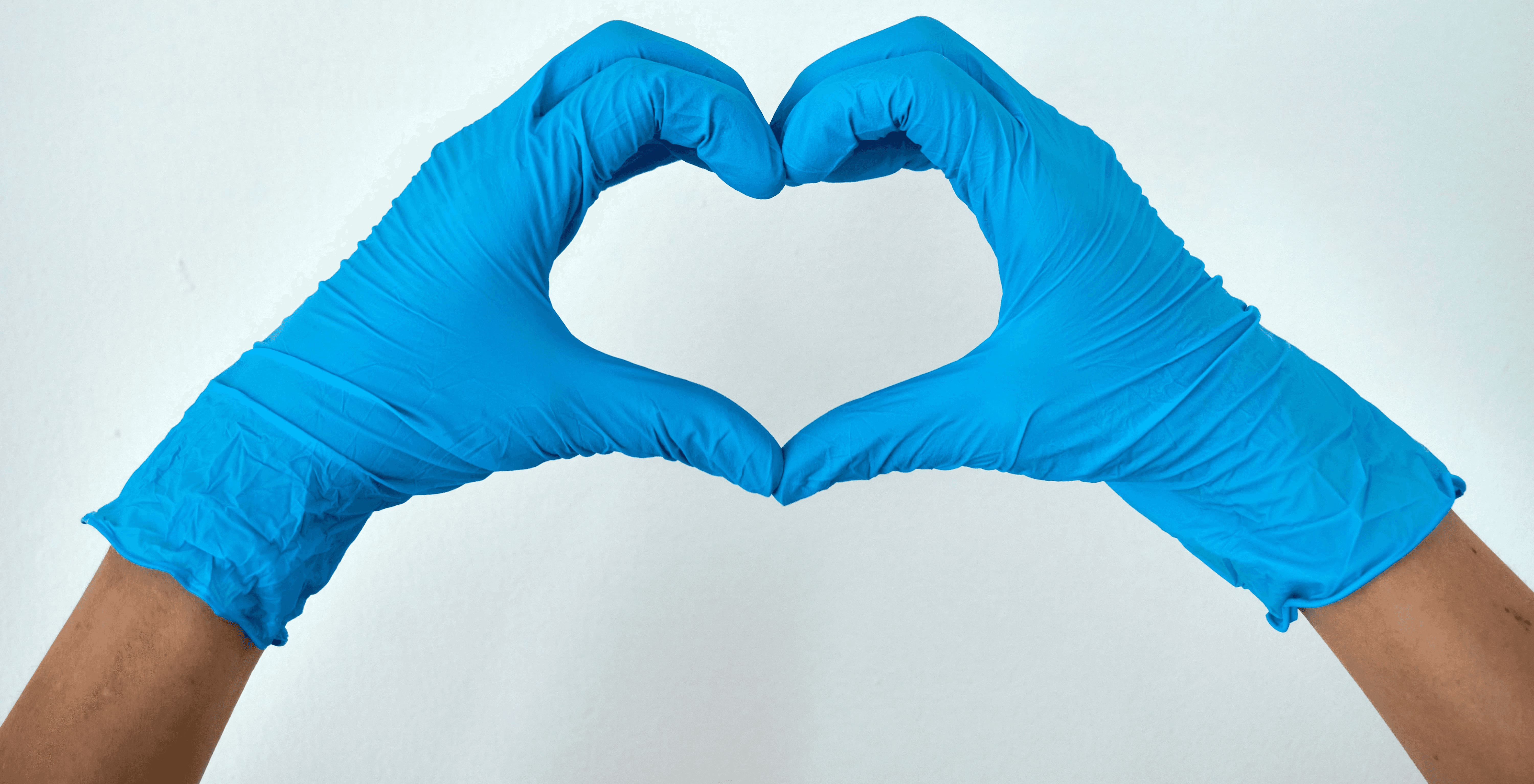person in blue pants lying on white surface