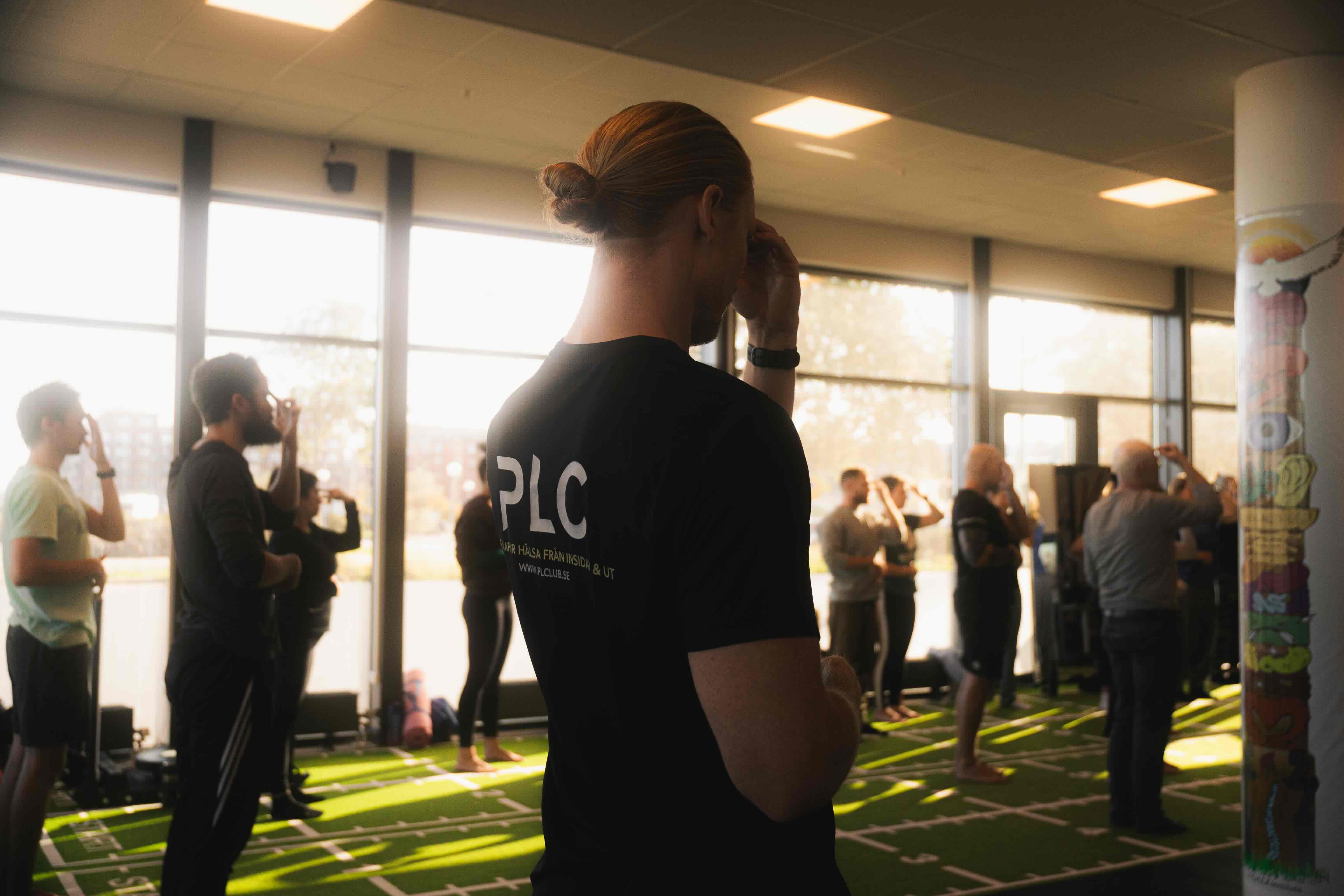 A row of basketball players with dreadlocks sitting on a bench, wearing purple jerseys with lightning patterns.