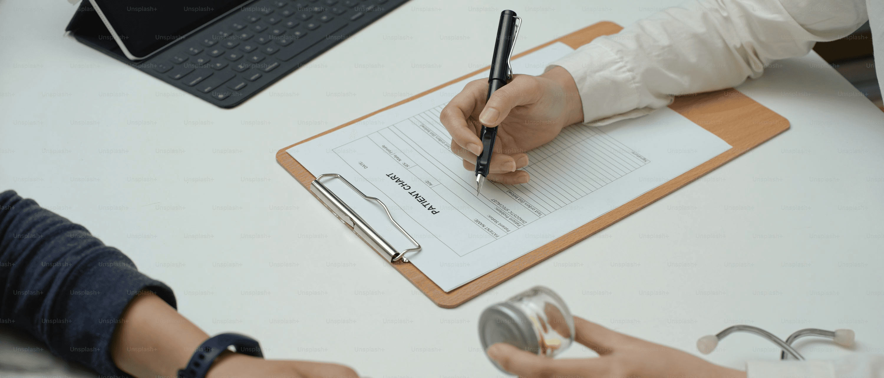  Doctor filling out a patient chart - Medical Report Writing