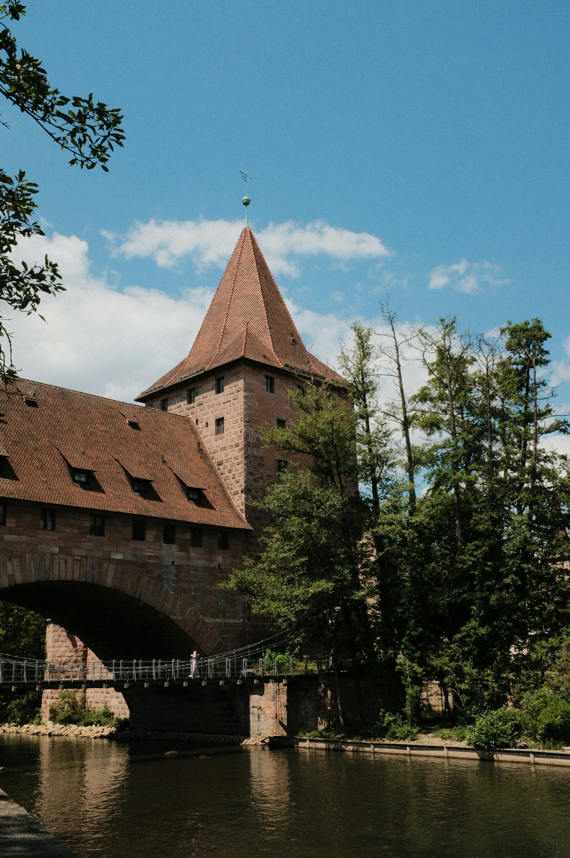 a large building with a bridge over a river
