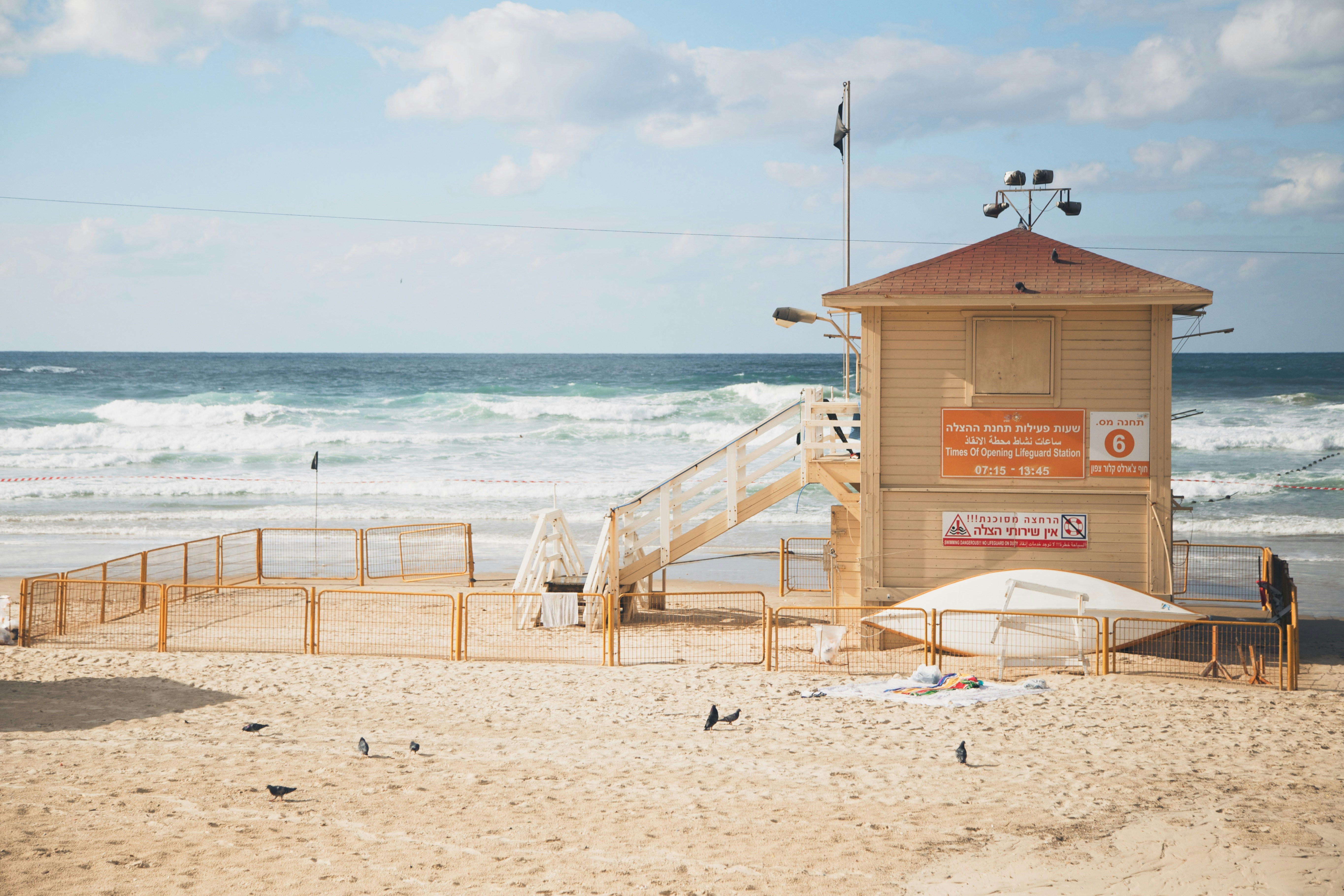 green chairs under umbrellas on shore