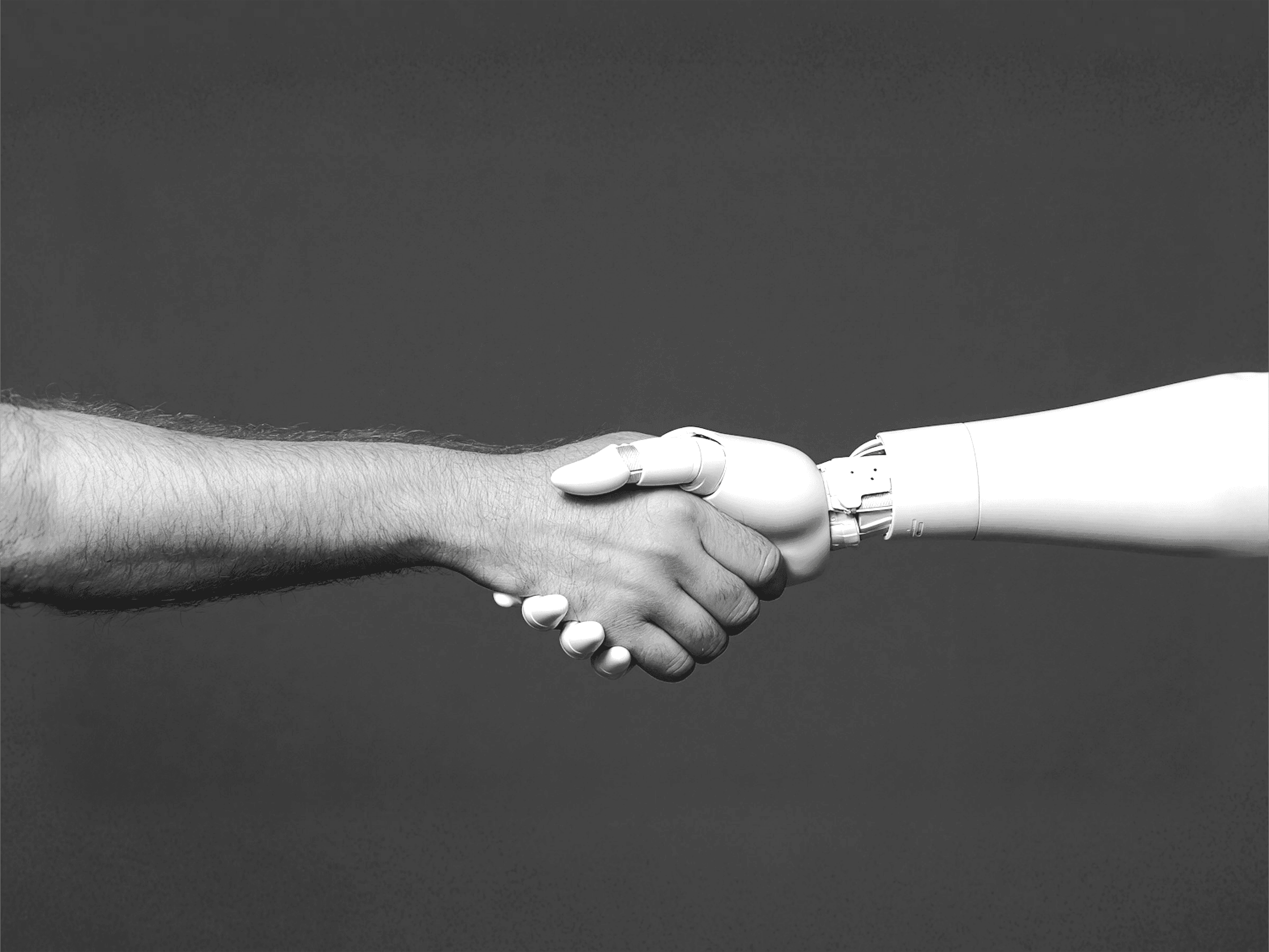 Image of AI and human shaking hands