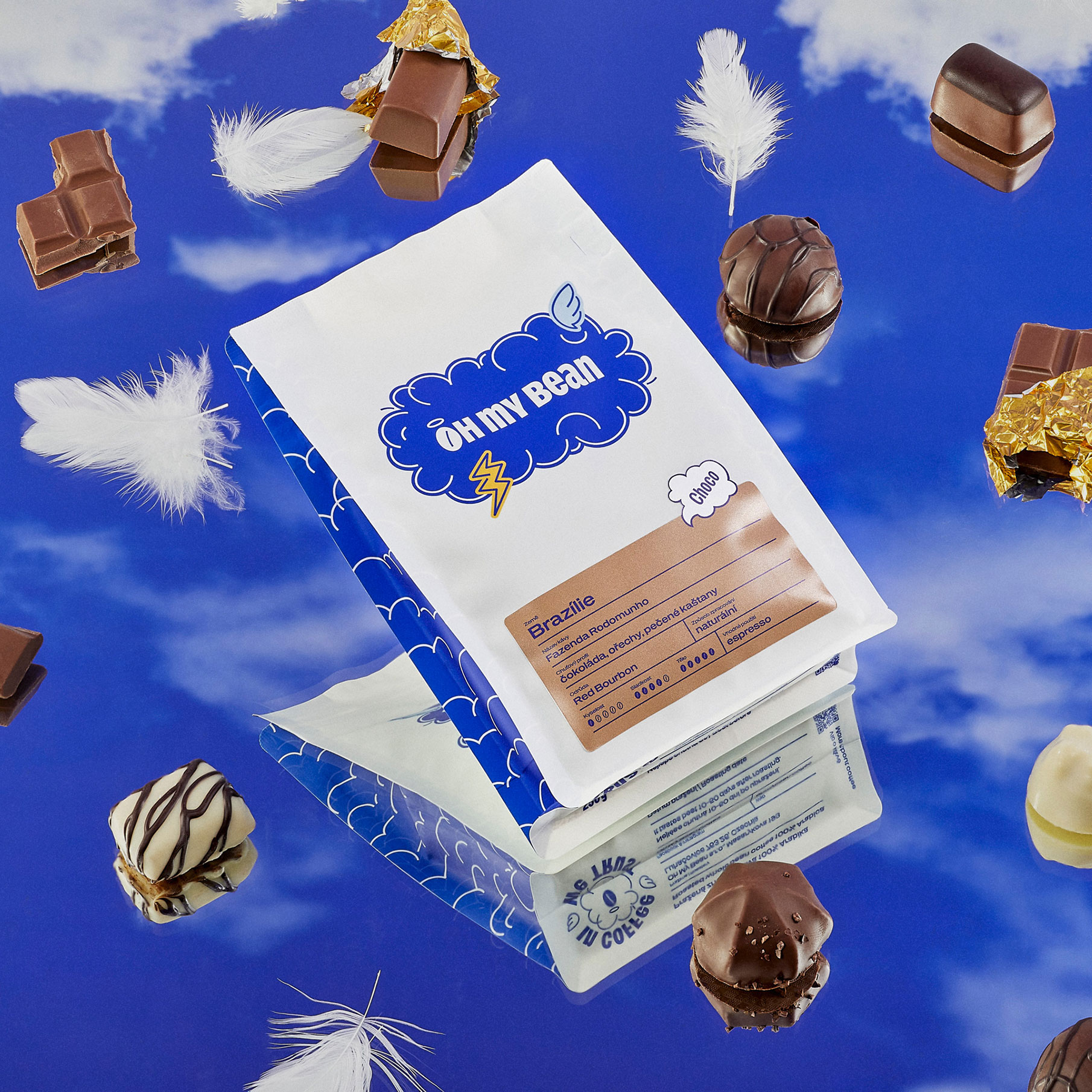 Oh My Bean Brazil coffee packaging photographed against a sky background with chocolate elements