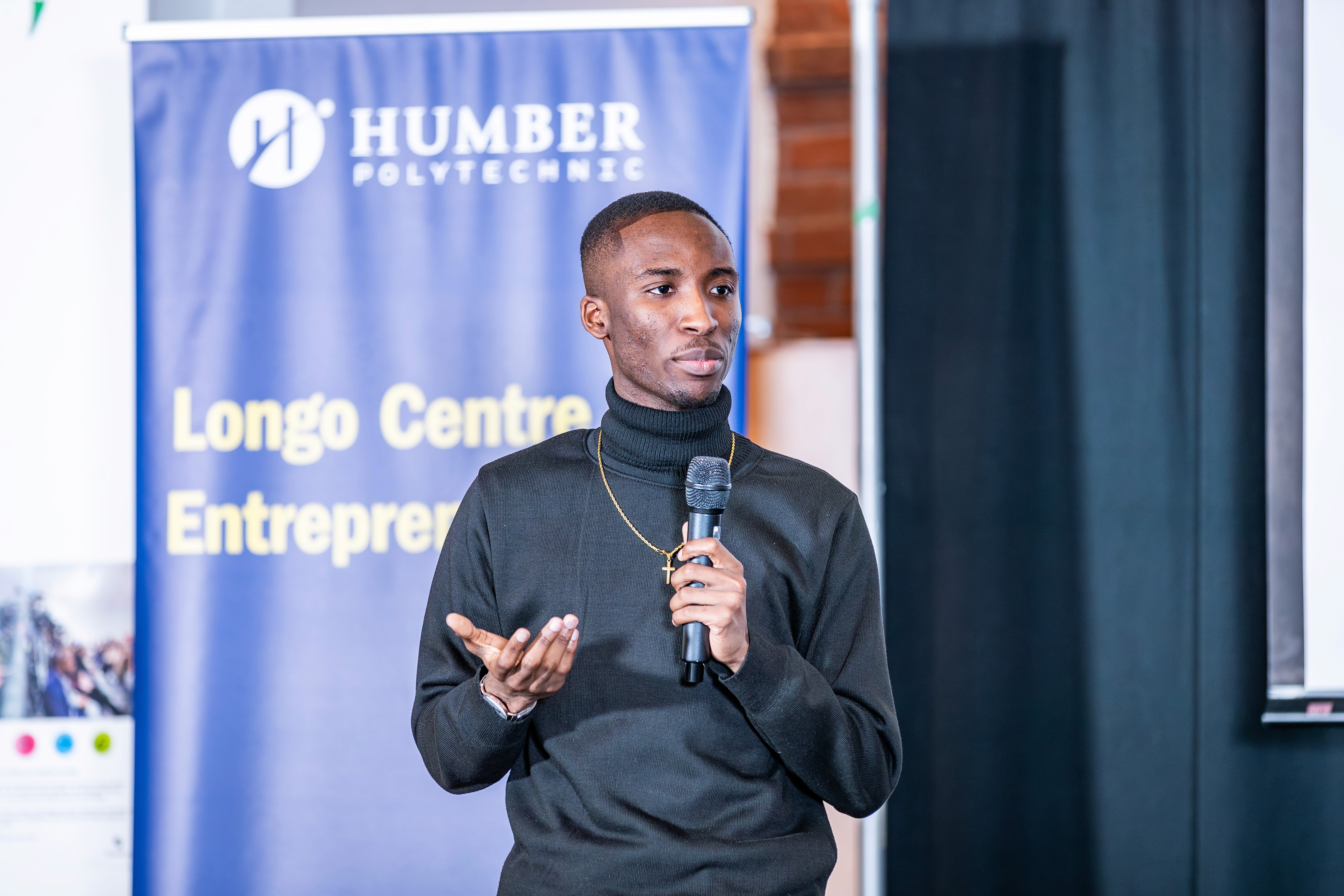 Portrait of a person in dark clothing speaking on a phone