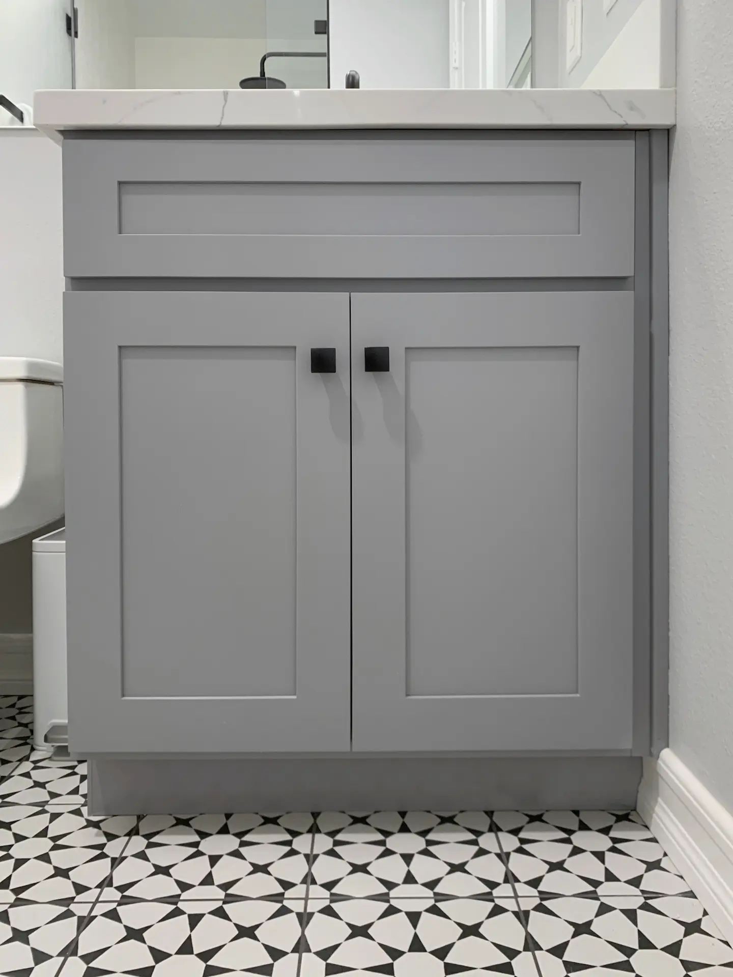 View of the guest bath vanity cabinetry, exemplifying modern elegance with Quartz countertops and stylish storage options. Photo by Todd Huge.