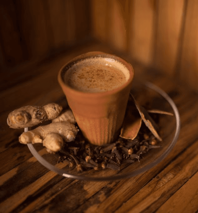 A beautifully plated dish featuring shrimp, colorful vegetables, and garnishes, set in a modern restaurant.