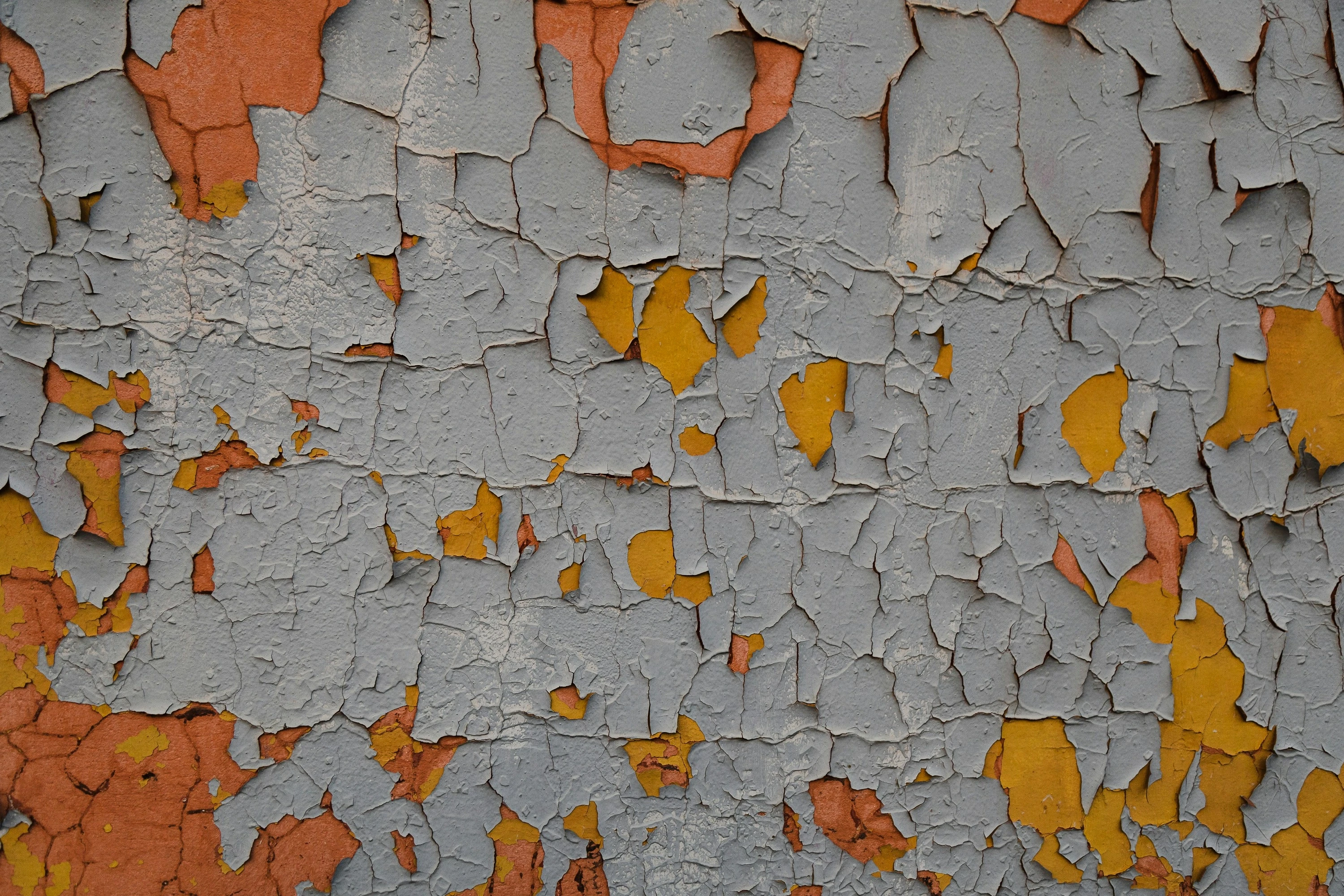 A close up of a peeling paint on a wall