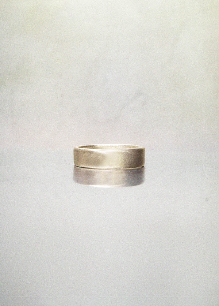 Silver ring on a light gray background