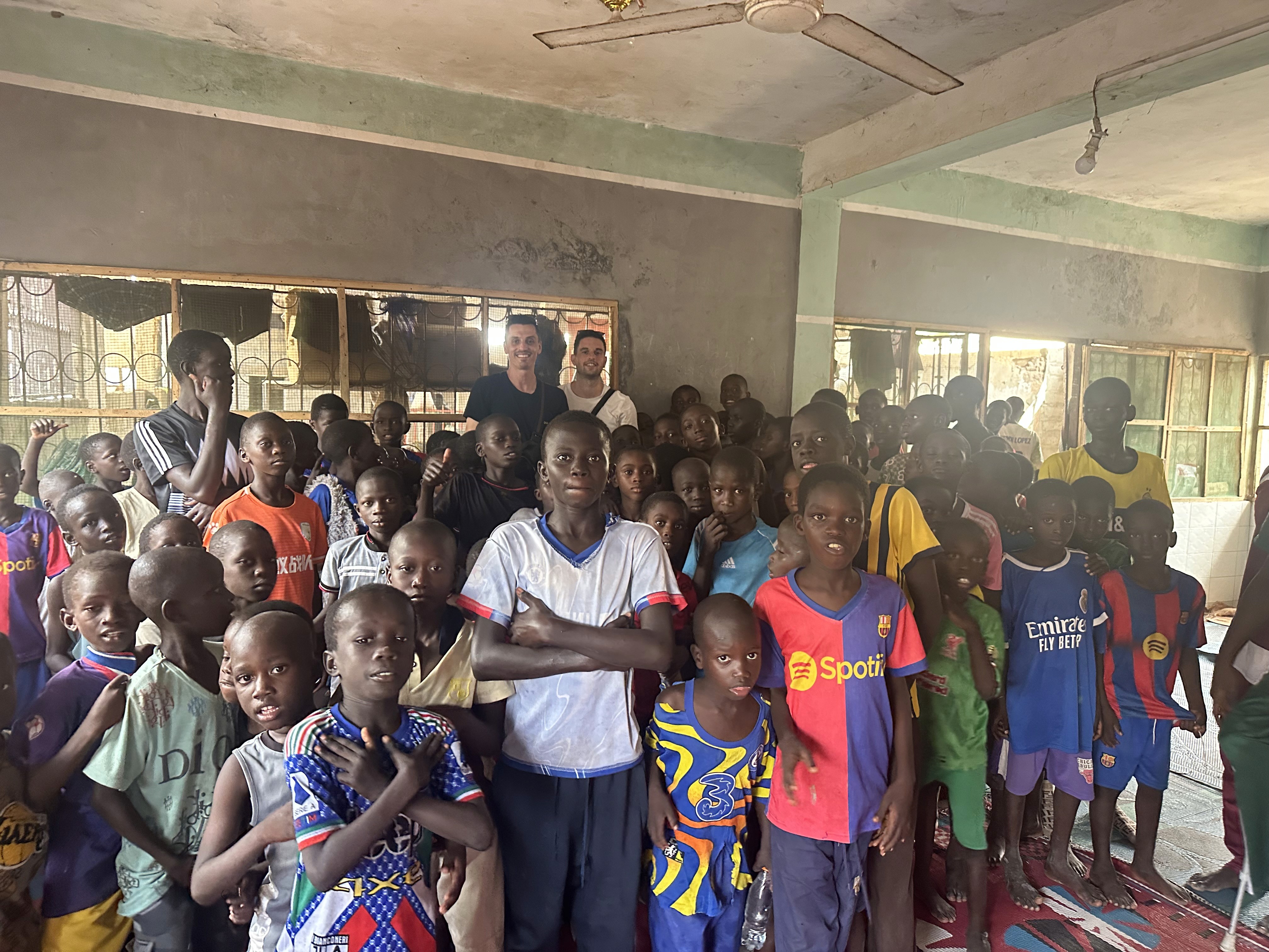 a group of children sitting on steps in front of a building