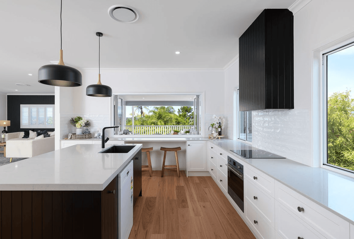 Bright Queensland kitchen with timber-look hybrid flooring that handles everyday spills and stains, designed for water resistance and easy cleaning in busy homes.