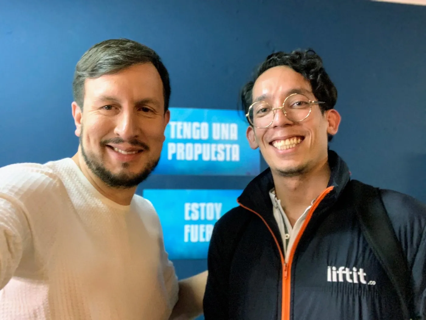 two people looking at a tablet and smiling