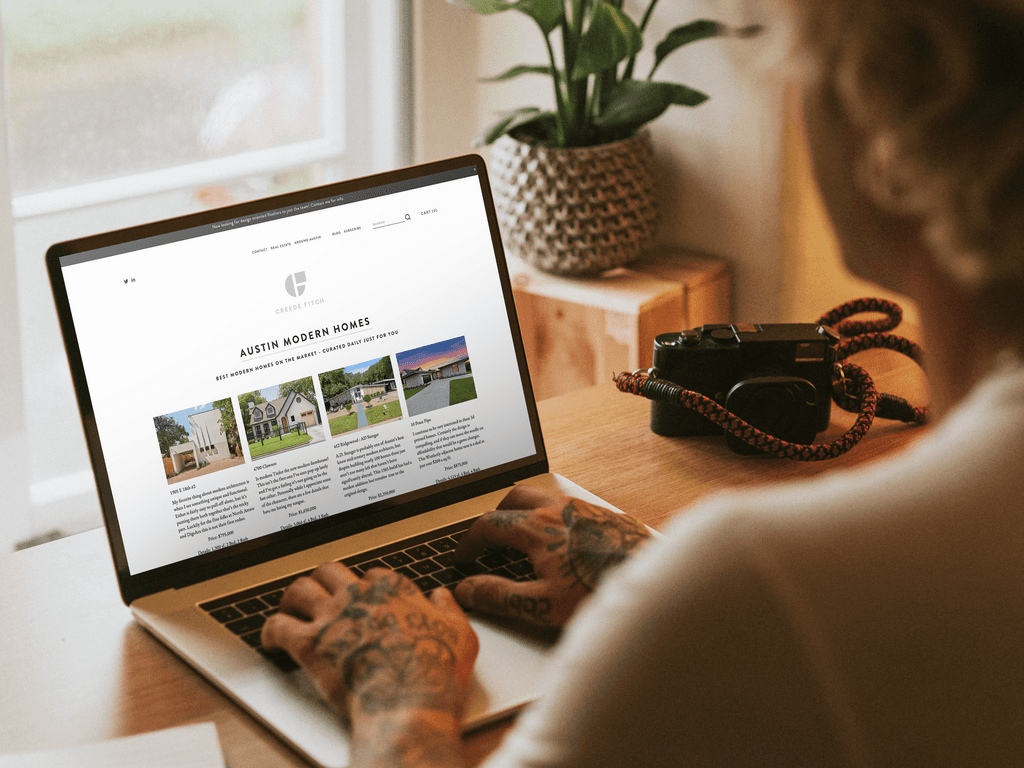 An image of laptop with creedefitch.com on the screen