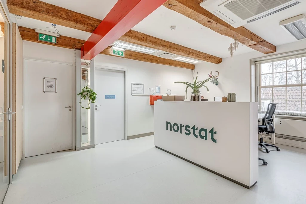Reception desk of the Norstat office with exposed beams