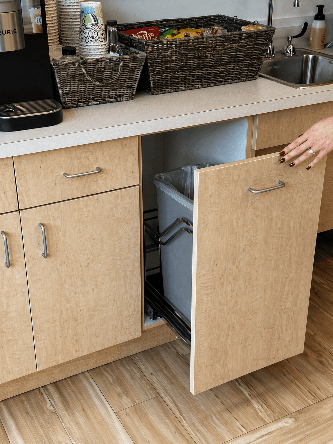 Custom cabinet with built-in pull-out trash drawer and white quartz countertop by QW Kitchen & Bath Austin