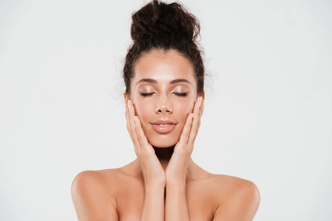 Close-up of a woman with clear glowing skin, representing acne treatment, eye rejuvenation, and double chin reduction for smoother, contoured results in Los Angeles.