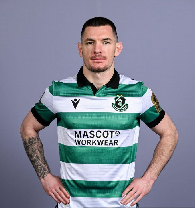 Man with arms crossed in a gym