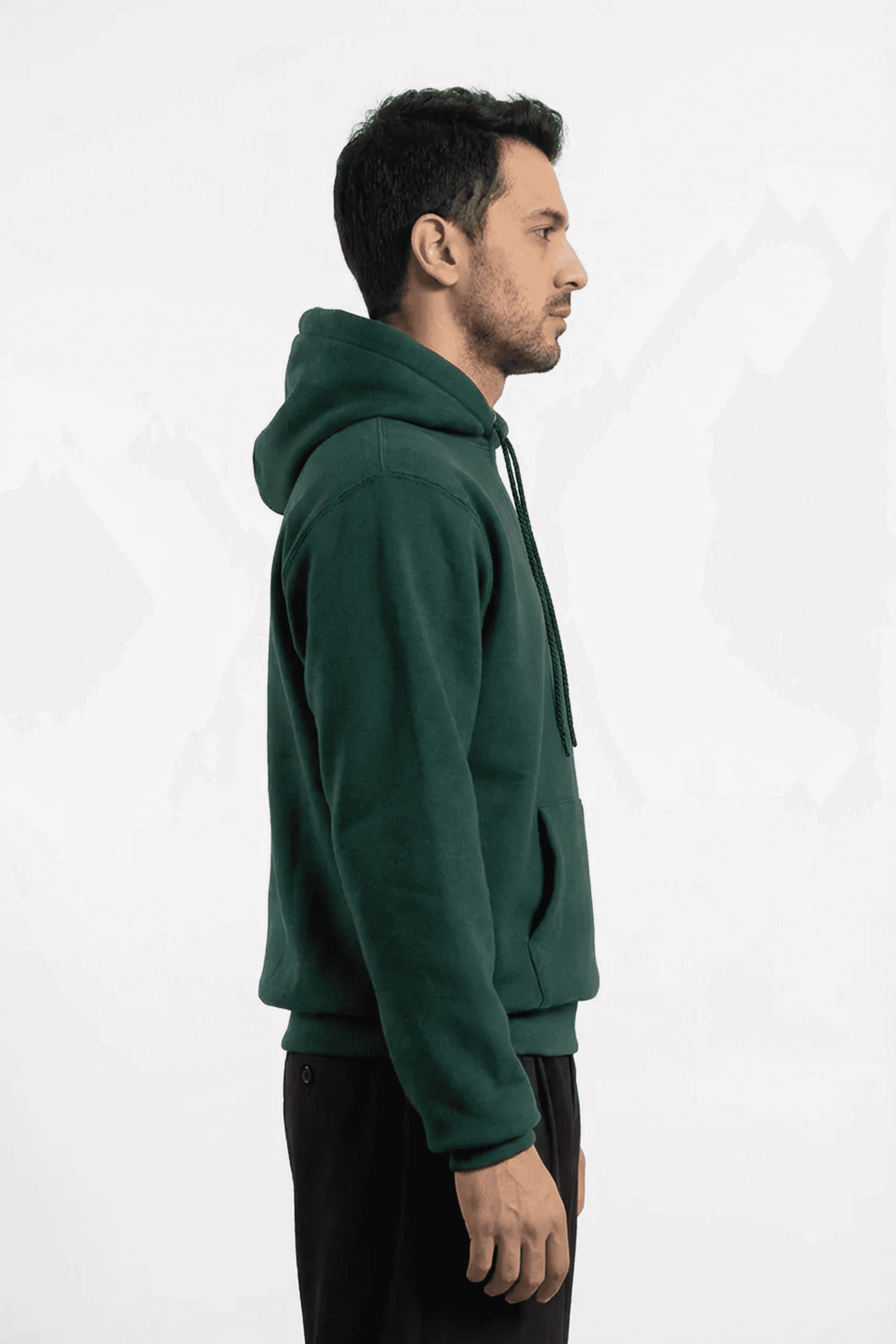 right side view of a model wearing a green hoodie