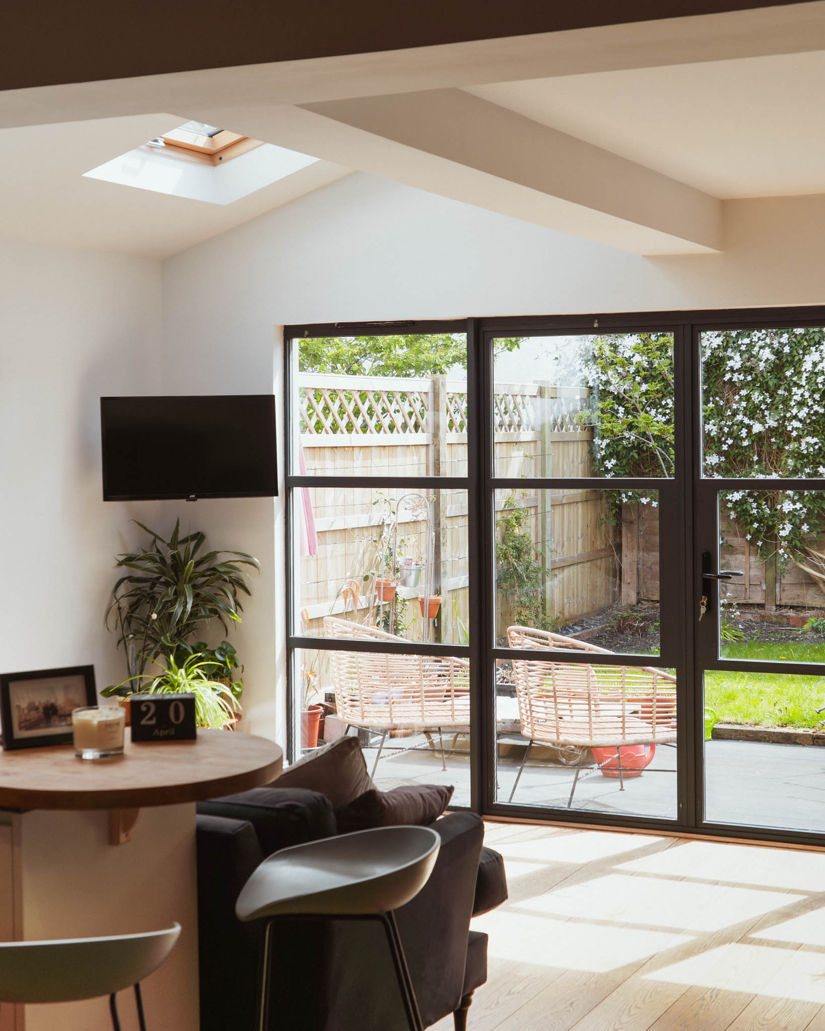 Bristol architect rear extension interior showing steel-framed glazed doors, rooflight and open plan kitchen dining living space, Bishopston