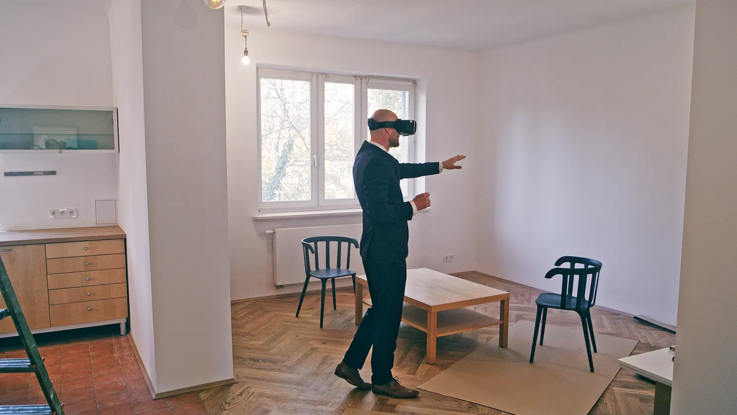 A person trying VR in a home are, image