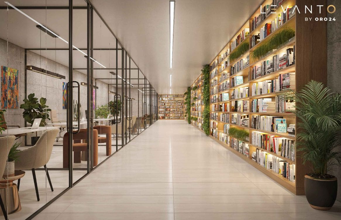 A long hallway lined with bookshelves and plants, showcasing the Levanto design by ORO24.