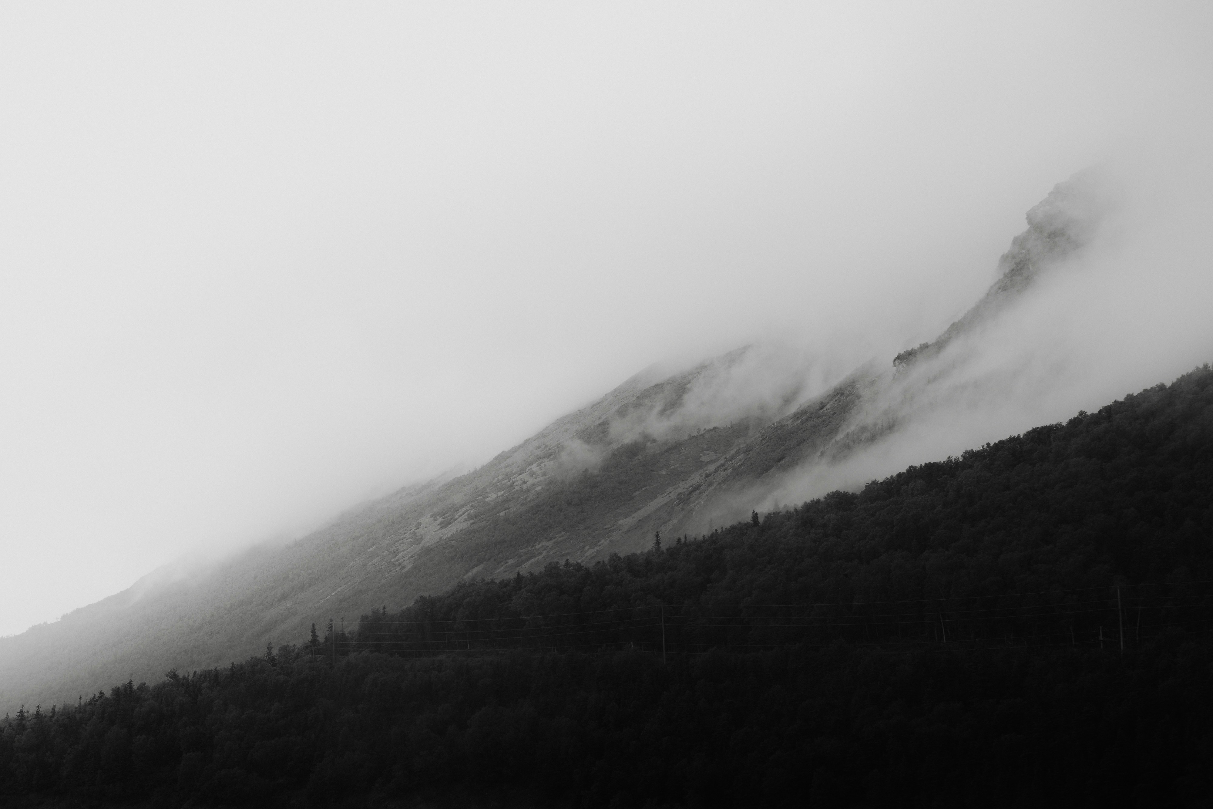 Misty mountains shrouded in fog on a dark day