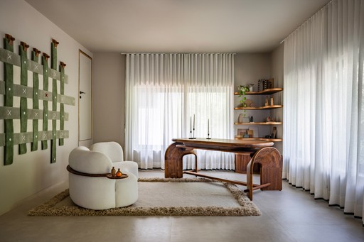 three people sitting in front of table laughing together