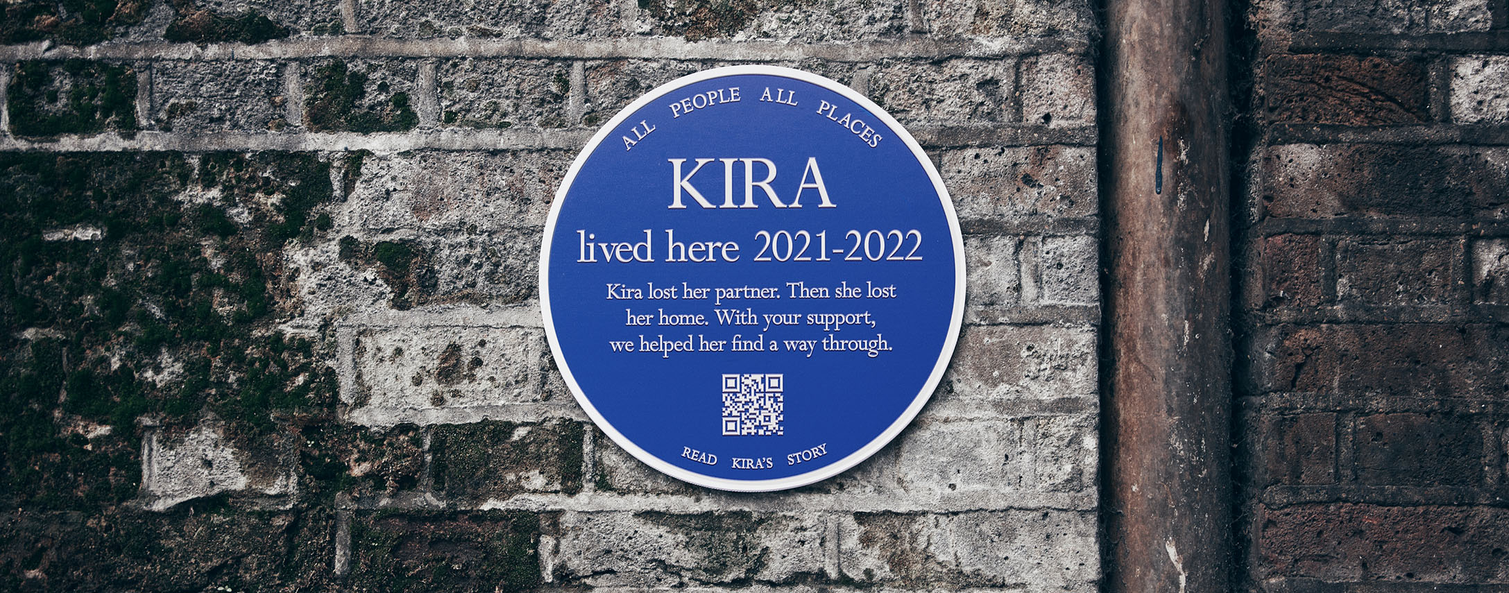 Blue plaque on a brick wall