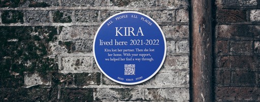 A blue plaque on a brick wall that says 'Kire lived here 2021-2022'
