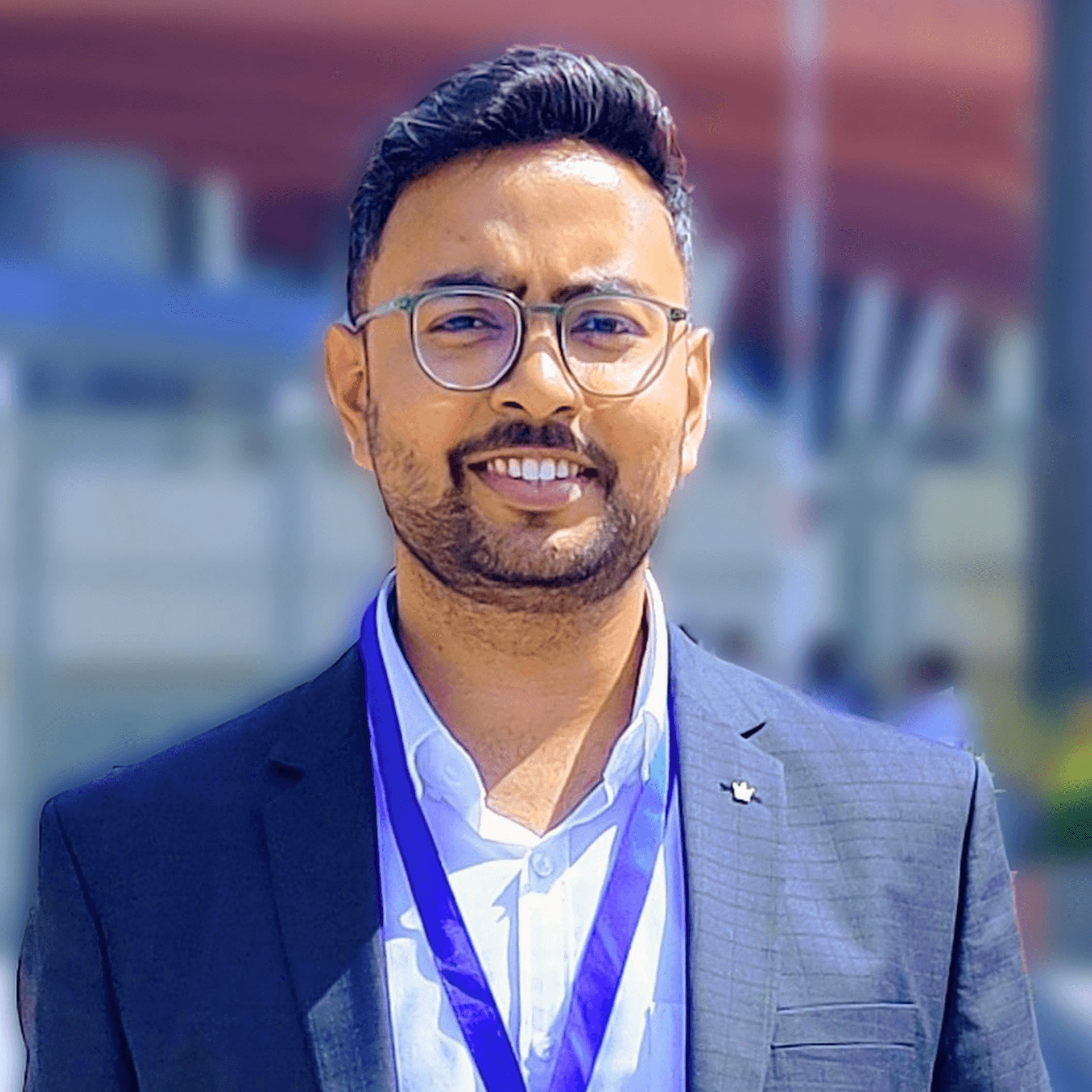 A person with dreadlocks and round glasses looks confidently at the camera. Neon blue and purple lighting creates a modern, artistic vibe.