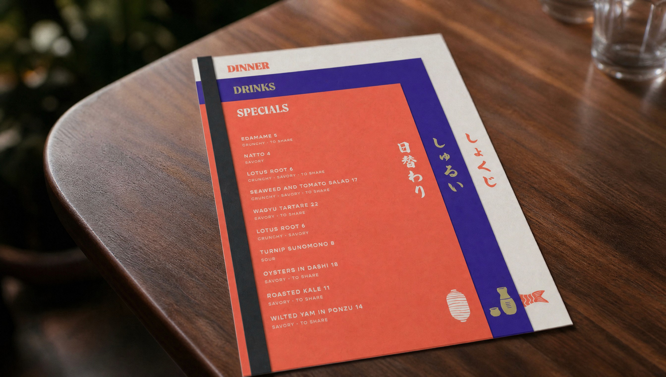 A beautiful, colorful 3 piece menu design for a Japanese restaurant, stacked on a midcentury table
