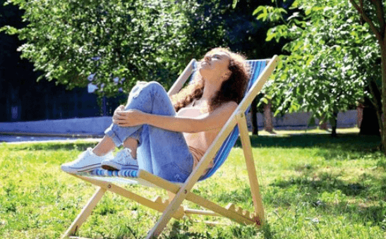 <img src="your-image.jpg" alt="A girl sitting in the backyard of a villa, enjoying the serene outdoor view." />
