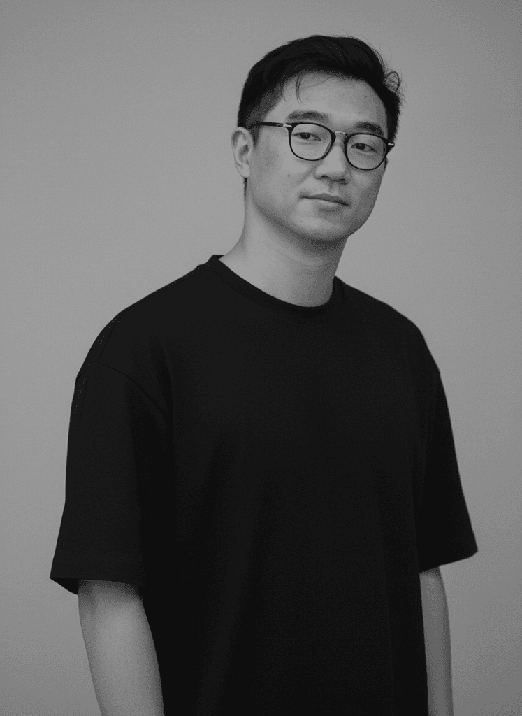 Young woman in a white shirt with a colorful gradient print, against a plain background.