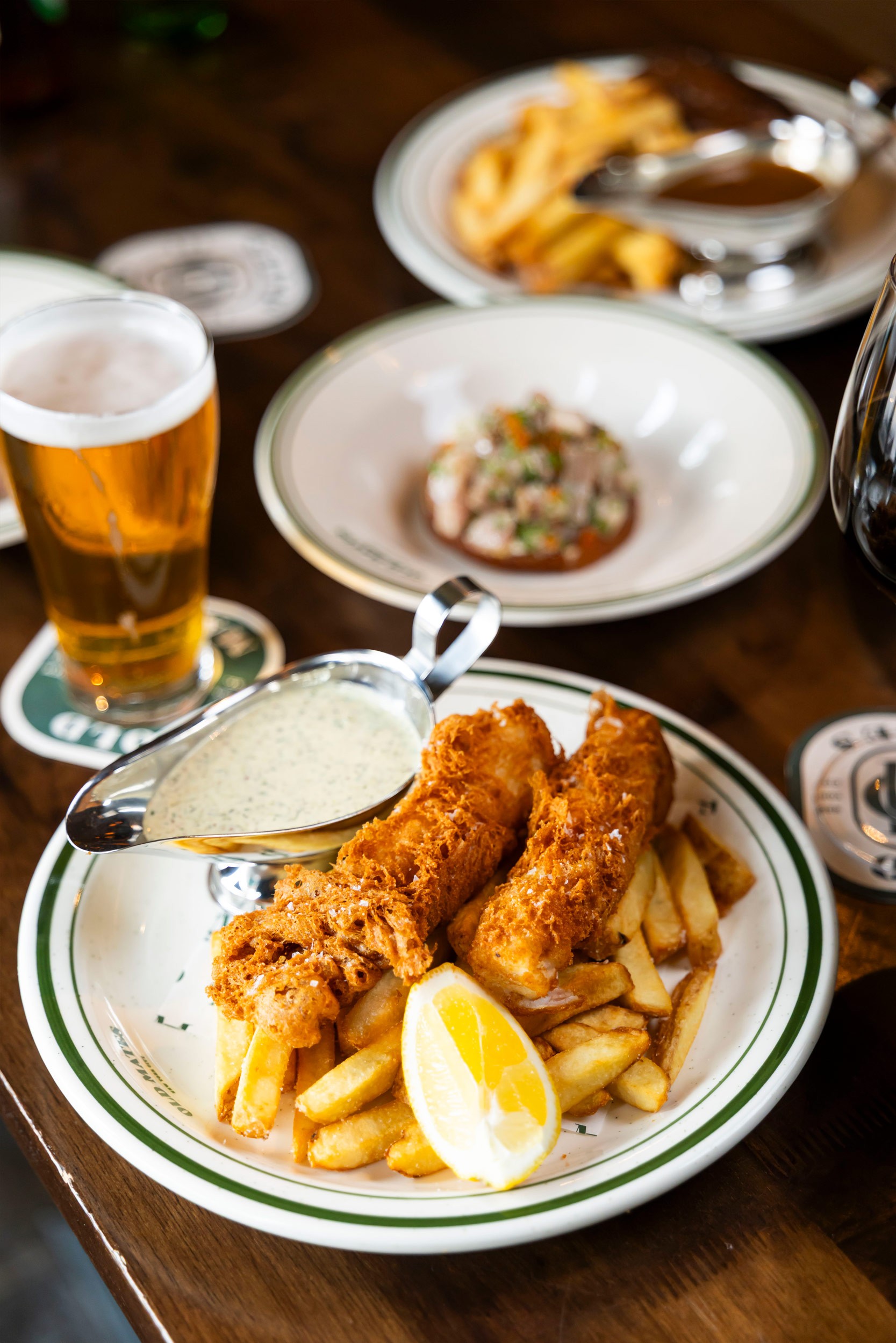 Old Mates brand detail, custom plates or merchandise with the pub logo.