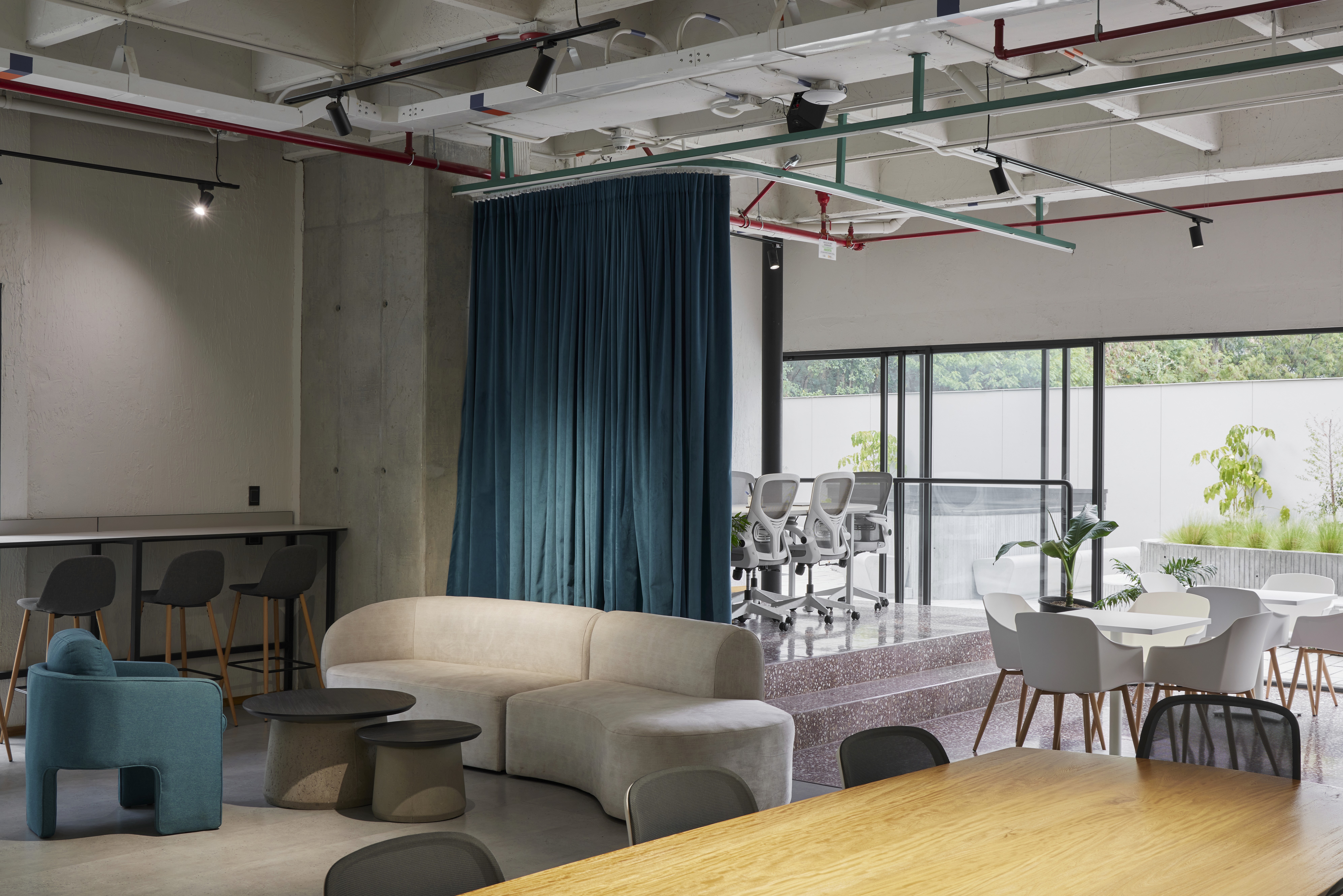 Double-height interior with flowing sculptural forms and warm raking light