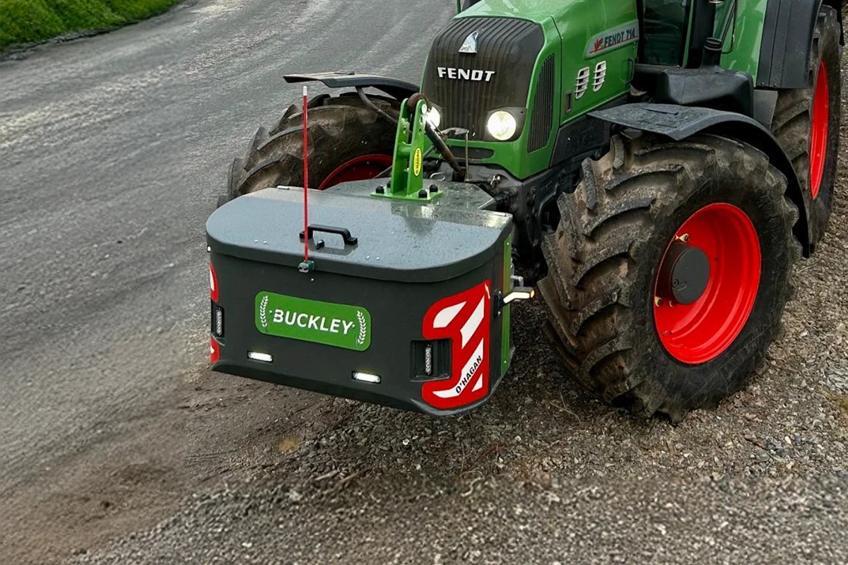 Green and green work box with green custom name plate attached to a Vendt green tractor with Red and black wheels pulled over on a country road 